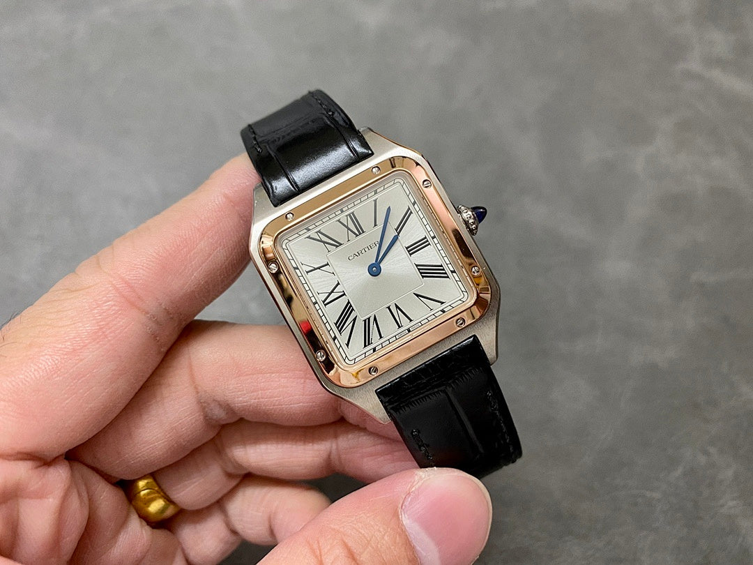 Cartier watch on hand; black leather strap, Roman numeral dial, rose-gold case.