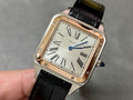 Cartier watch with black leather strap and Roman-numeral dial, gold-tone case.