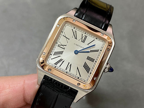 Cartier watch with black leather strap and Roman-numeral dial, gold-tone case.