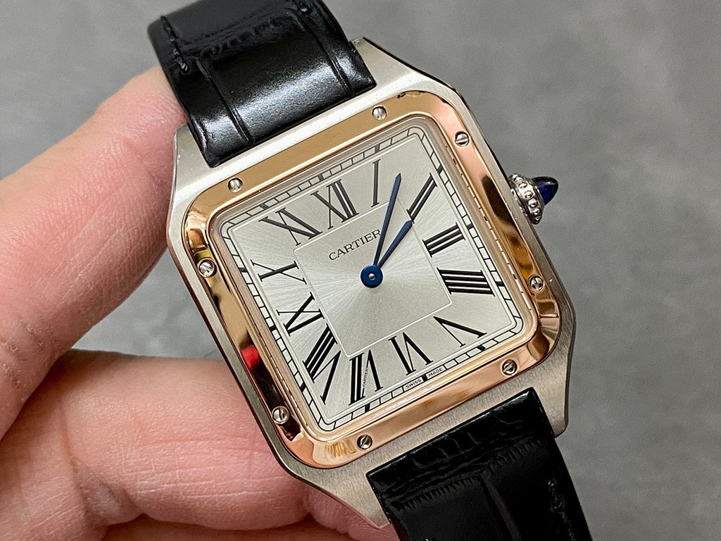 Cartier watch angled view with black leather strap and silver dial Roman numerals.