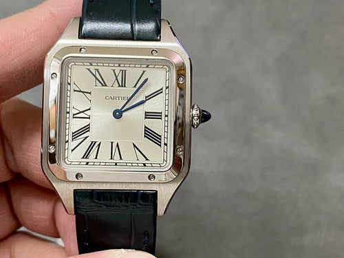 Cartier watch front view with black leather strap and square silver case, Roman dial.