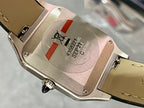 Cartier watch case back with serial text and black leather strap, silver-toned.