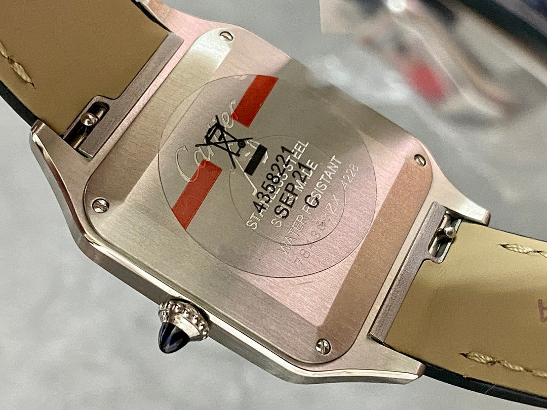 Cartier watch case back with serial text and black leather strap, silver-toned.