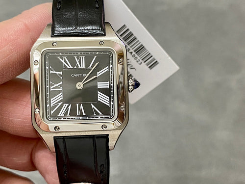 Cartier watch angled view, black leather strap and silver case with Roman numeral dial