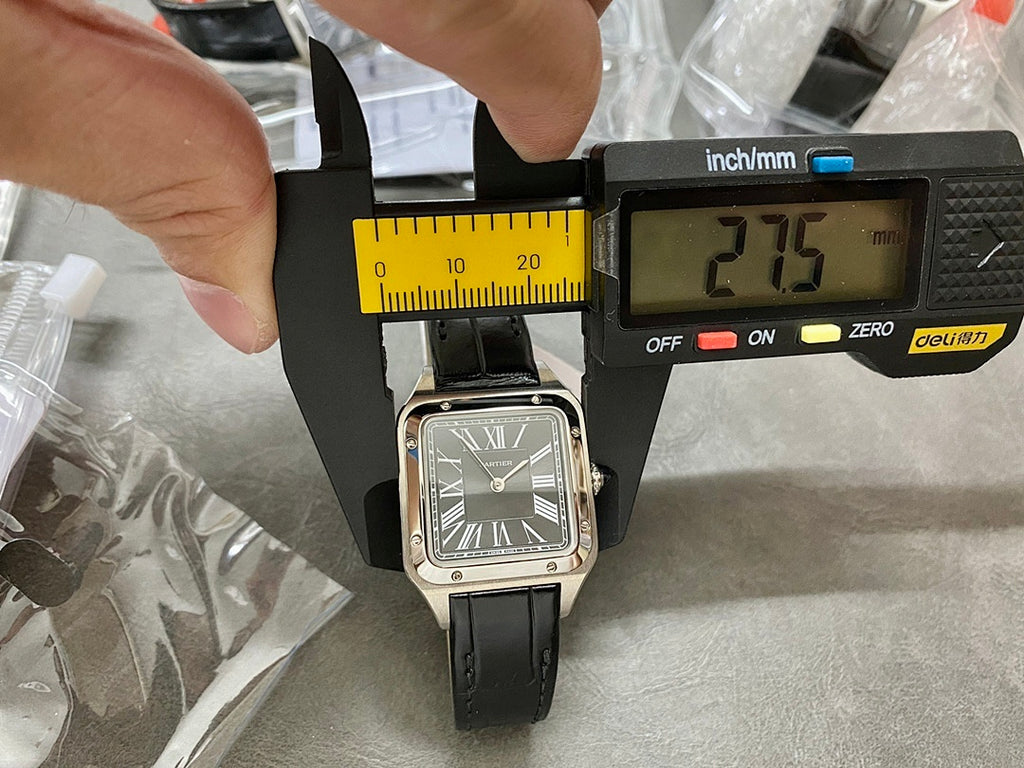 Cartier watch with black leather strap and silver case, Roman numeral dial on measuring jig