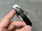Cartier watch back view with black leather strap and silver case, buckle and lug detail