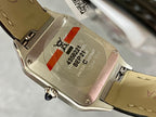 Cartier watch case back detail, black leather strap with clasp and stamped markings