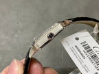 Cartier watch side profile with crown, black leather strap and silver case edge detail