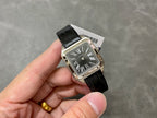 Cartier watch on hand, black leather strap and silver rectangular case with Roman numeral dial