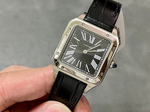 Cartier watch with black leather strap and rectangular silver case, Roman numeral dial