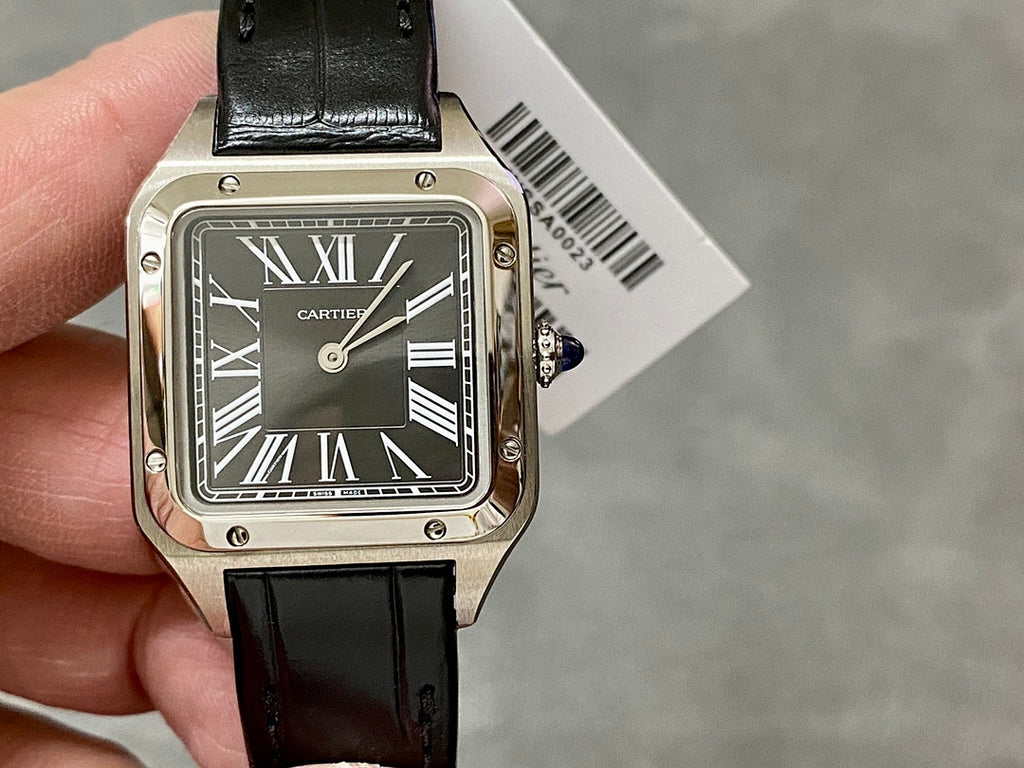 Cartier watch front view with black leather strap and silver case, Roman numeral dial