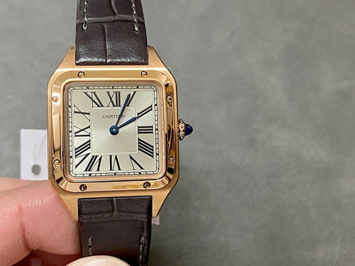 Gold-tone wristwatch with black leather strap and Roman numeral dial, angled view.