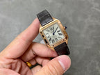Gold-tone wristwatch with black leather strap and Roman numeral dial, held in hand.