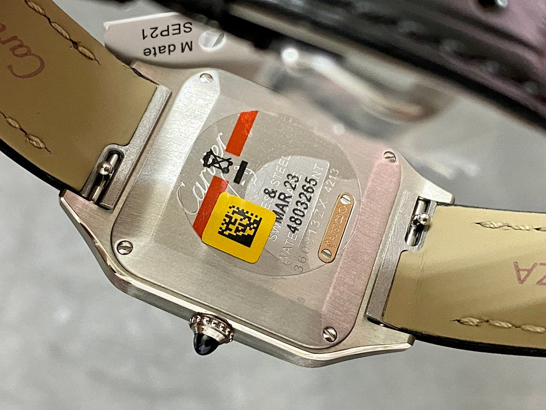 Cartier watch caseback with serial markings and leather strap, close-up view