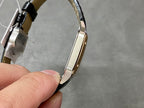 Cartier watch with rose gold-tone case and black leather strap, curved side profile