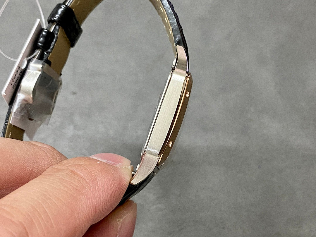 Cartier watch with rose gold-tone case and black leather strap, curved side profile