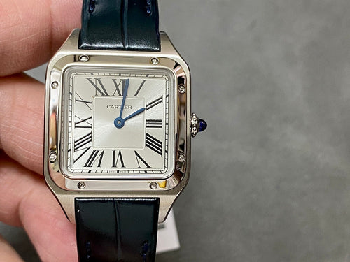 Cartier wristwatch with rectangular silver case, white dial, black leather strap