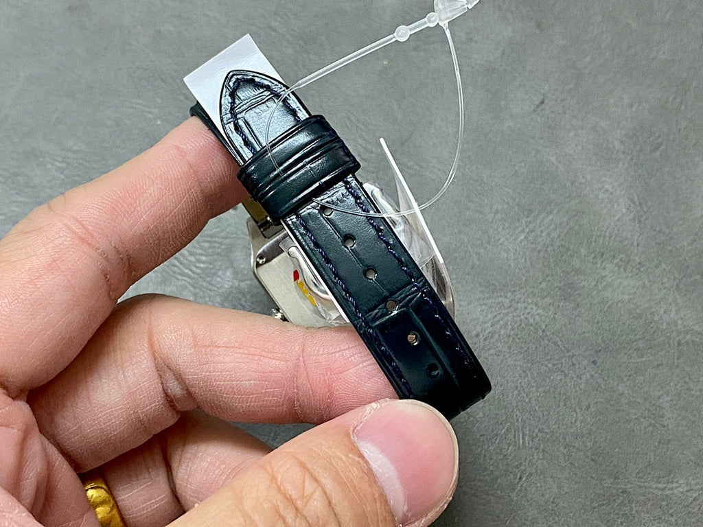 Cartier wristwatch clasp view with black leather strap and metal buckle