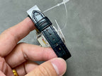 Cartier wristwatch clasp view with black leather strap and metal buckle
