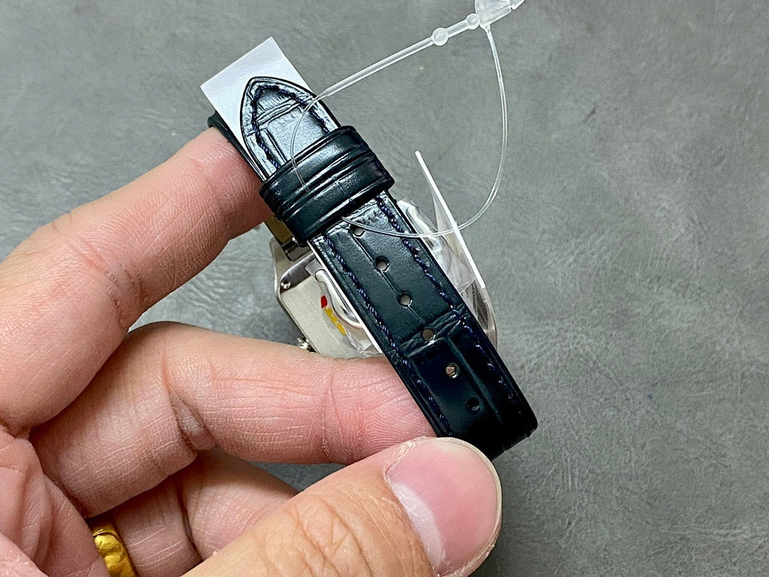 Cartier wristwatch clasp view with black leather strap and metal buckle