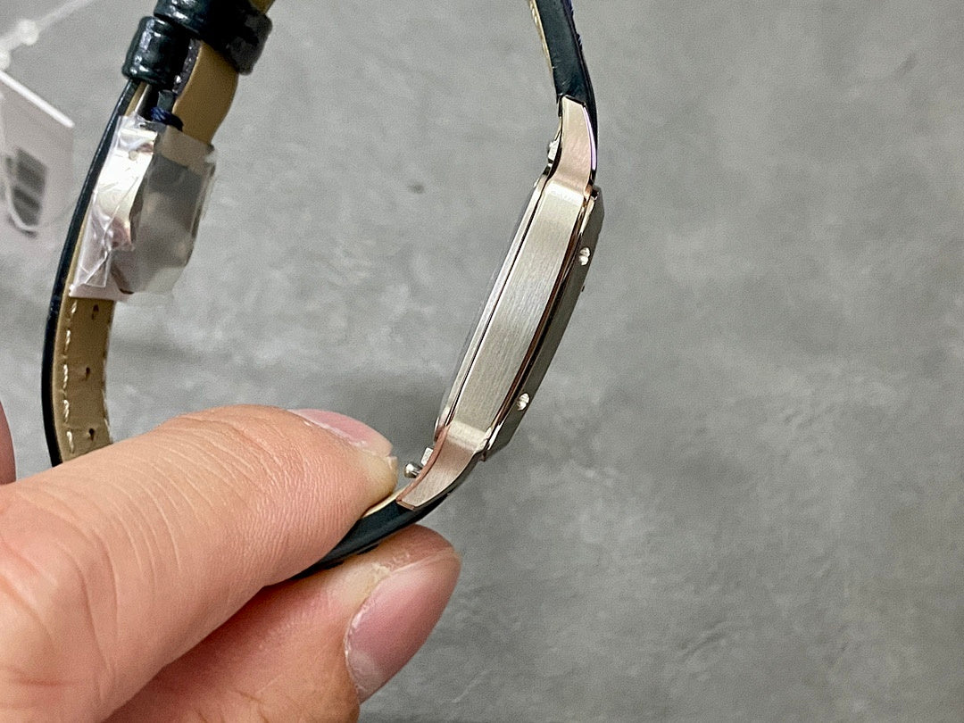 Cartier wristwatch side view with black leather strap and polished metal bezel