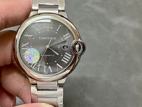 Cartier automatic wristwatch with black dial, Roman numerals, steel bracelet and crown