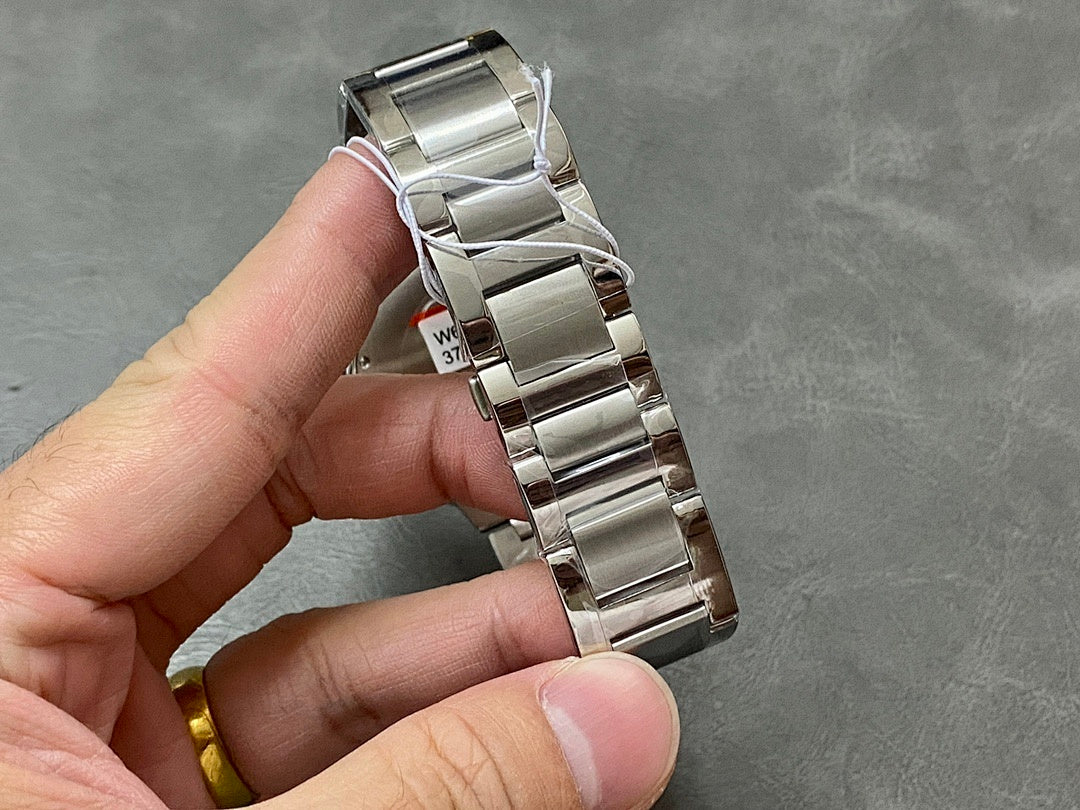 Cartier steel watch bracelet with linked bands held in hand