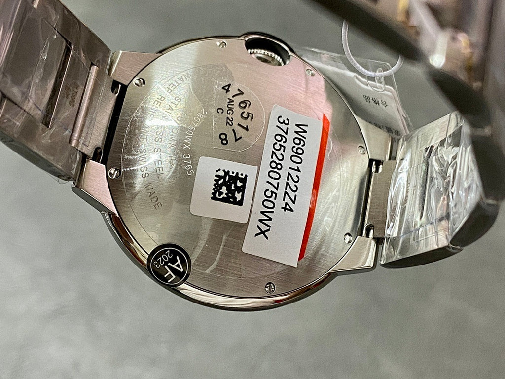 Cartier watch caseback with metal back plate and paper label