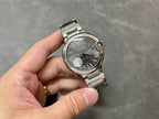 Cartier automatic wristwatch, black dial with Roman numerals, steel bracelet