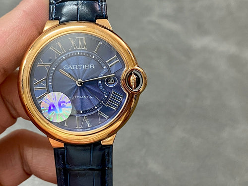 Cartier watch front view with blue dial, gold accents, Roman numerals, blue leather strap