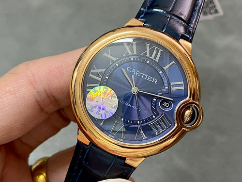 Cartier watch with gold bezel, blue dial, Roman numerals, and blue leather strap