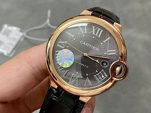 Cartier watch with rose-gold case, black leather strap, dark dial, Roman numerals