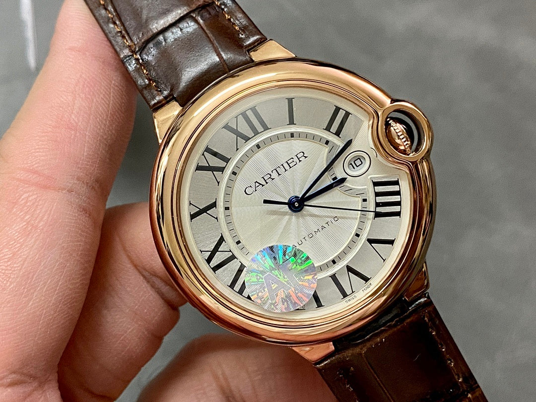 Cartier watch close-up with rose-gold case, white dial, Roman numerals, date window