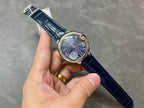 Cartier round watch with blue dial and blue leather strap held in hand