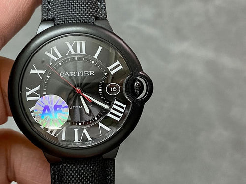 Cartier wristwatch showing black dial with Roman numerals and date window 16 on black strap