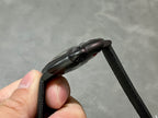 Cartier wristwatch side profile with black case and textured black strap