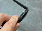 Cartier wristwatch from side angle with black case and black textured strap