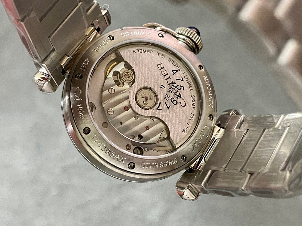 Cartier watch caseback with exposed mechanical dial and engraved markings