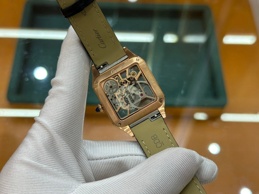Gold-tone square wristwatch with green leather strap, angled side view