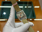 Cartier watch with leather strap and rectangular silver case, visible mechanical movement detail