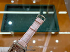 Cartier watch with light pink leather strap and silver buckle clasp, shown in full band view
