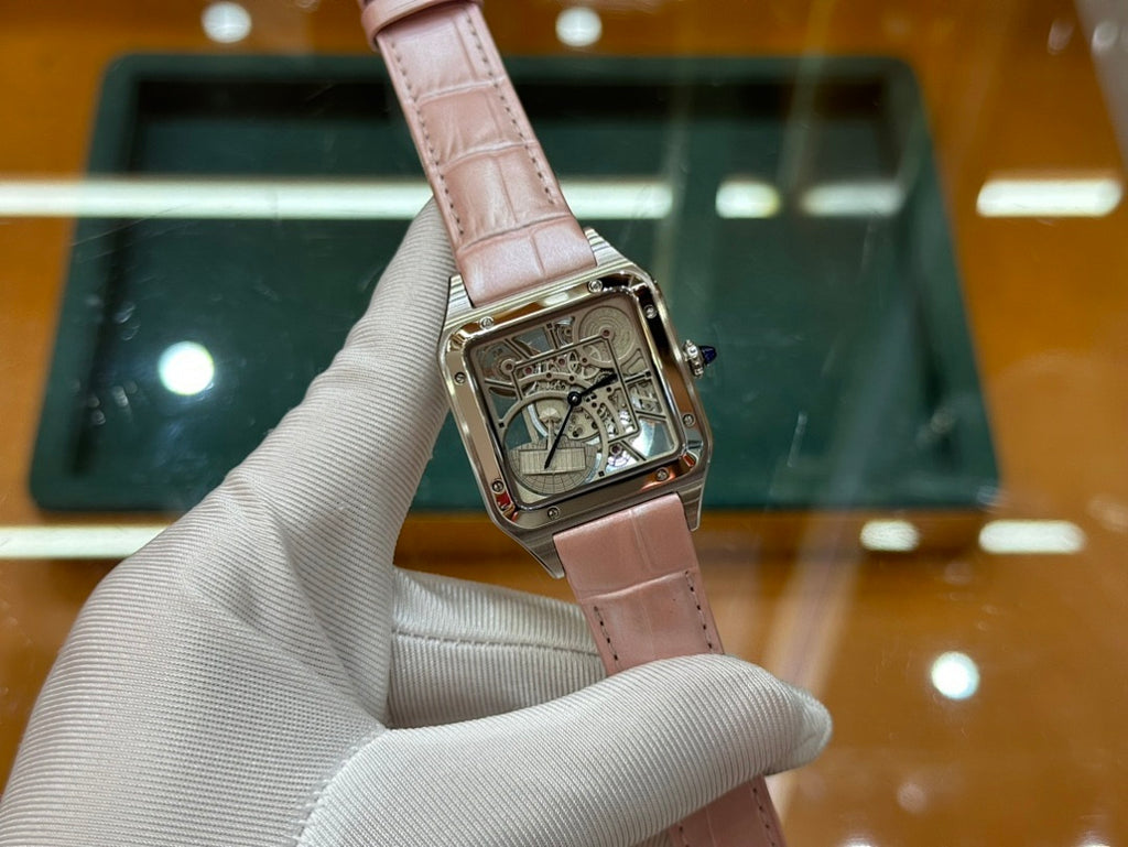 Cartier watch with light pink leather strap and square silver case, close-up of skeleton dial