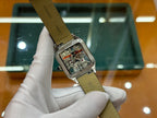 Rectangular skeleton dial watch with leather strap underside showing engraved markings