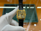 Cartier rectangular wristwatch with black leather strap and gold-tone case
