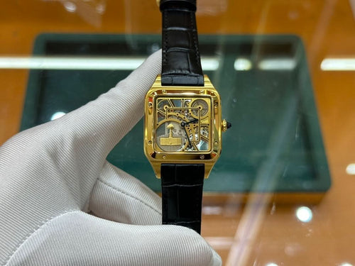 Cartier rectangular wristwatch with black leather strap and gold-tone case