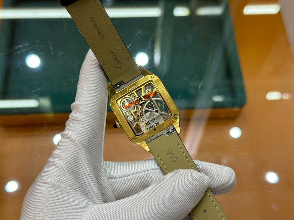 Cartier rectangular wristwatch on black leather strap, gold-tone case and dial
