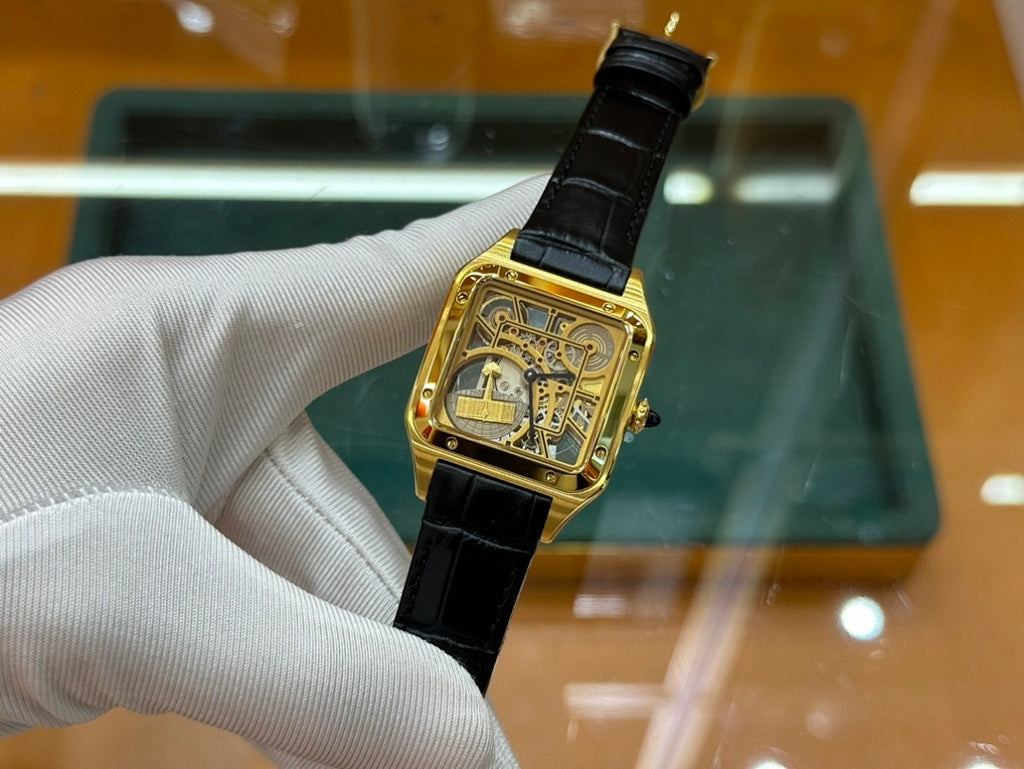 Cartier rectangular wristwatch with black leather strap and gold-tone dial