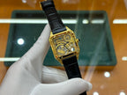 Cartier wristwatch front view with black leather strap and gold-tone case