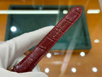 Red leather Cartier watch strap with gold-tone square case, side angle