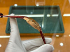 Cartier watch with red leather strap and gold-tone case, underside side view